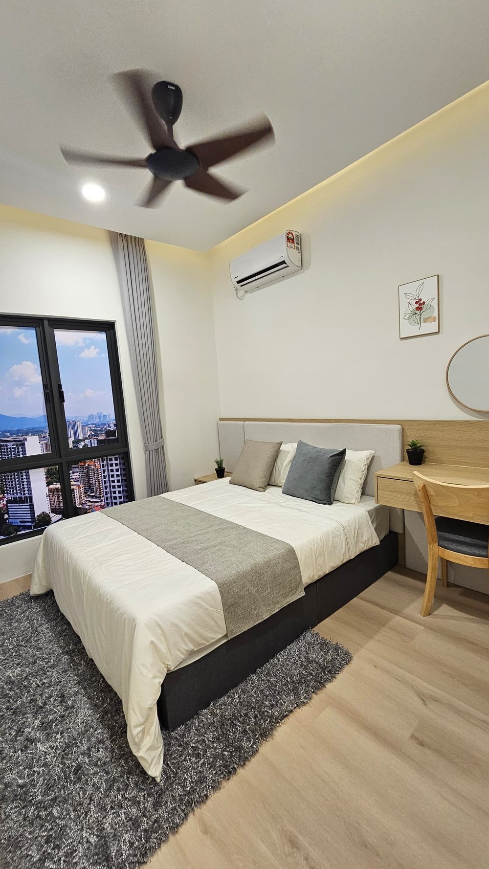 Furnished bedroom with a high-floor city view